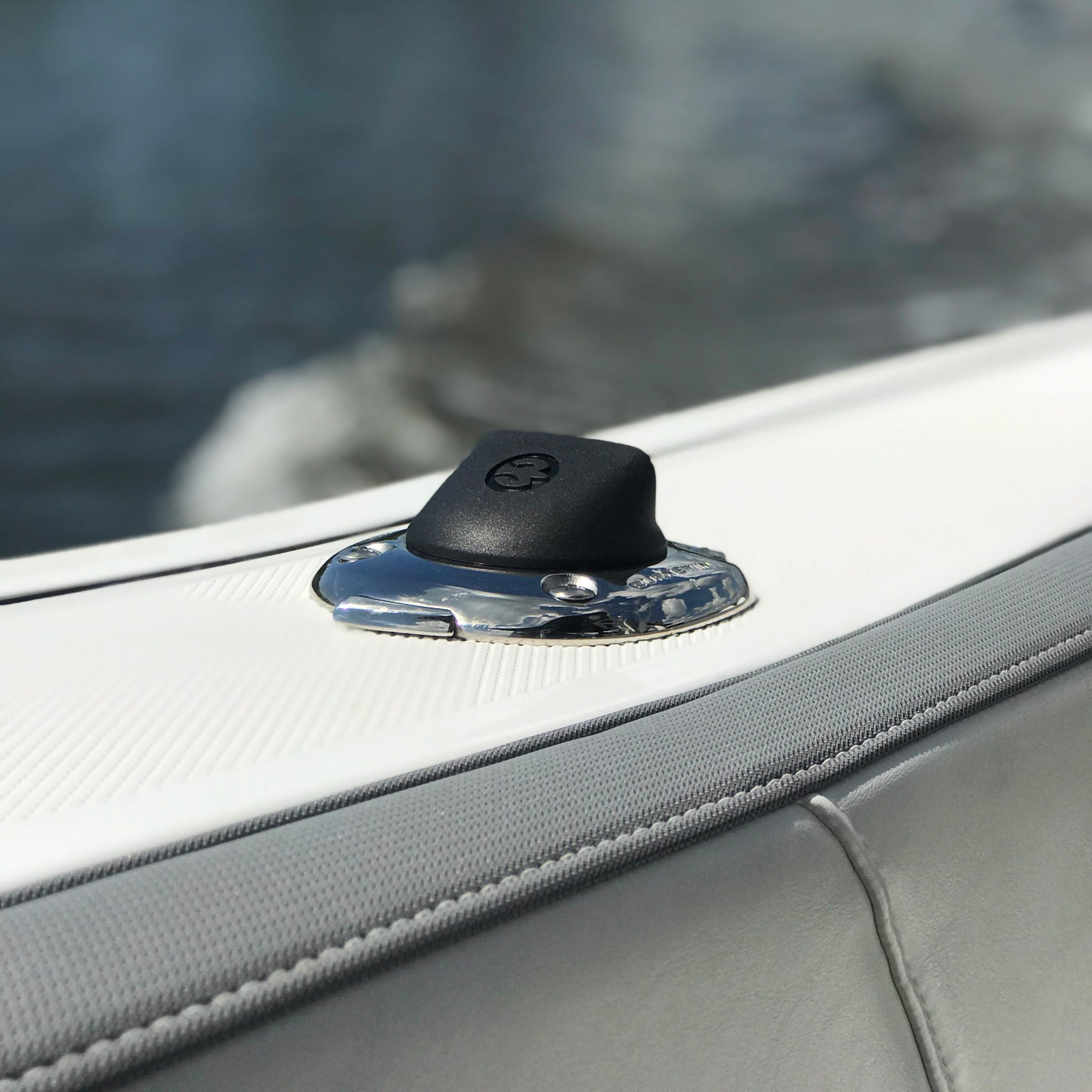 A closeup view of the Burnewiin Burnewiin CS3080 Boat Cover Support Socket mounted on a gunwale.