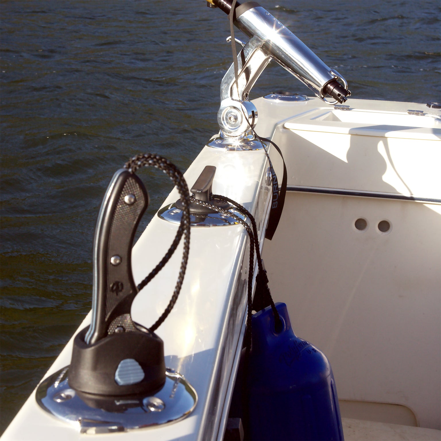 Looking down the side of a fishing boat, the Burnewiin KN5610 5-inch Ocean Knife is inserted into a GM650 mount on the port side of the gunwale.