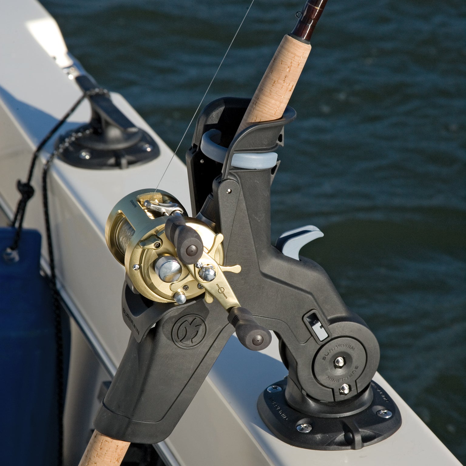 A closeup from the top and side of a Burnewiin RH5710 Rod Holder secured with a fishing rod and mounted with the GM400 on the gunwale.