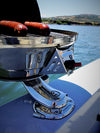 A Magma round marine grill cooking sausages on a boat, mounted with the Burnewiin BQ6600 6-inch Offset Insert Adapter.