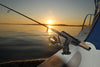 With the sun setting in the background, a fishing boat is mounted with the Burnewiin RH3740 Rod Holder on the port gunwale.