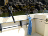The Burnewiin TW1010 Burnewiin Towel next to an RH3740 Rod Holder clipped to a GM650 mount on the starboard gunwale of a fishing boat. 