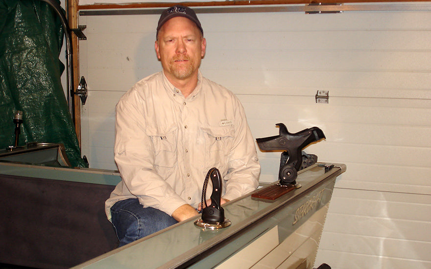 Testimonial photo By Doug Krauss kneeling in his boat outfitted with Burnewiin products.